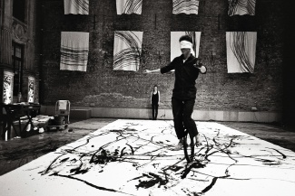 blindfolded artist on a unicycle 