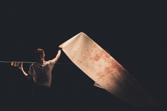a person holding an a big artwork in paper